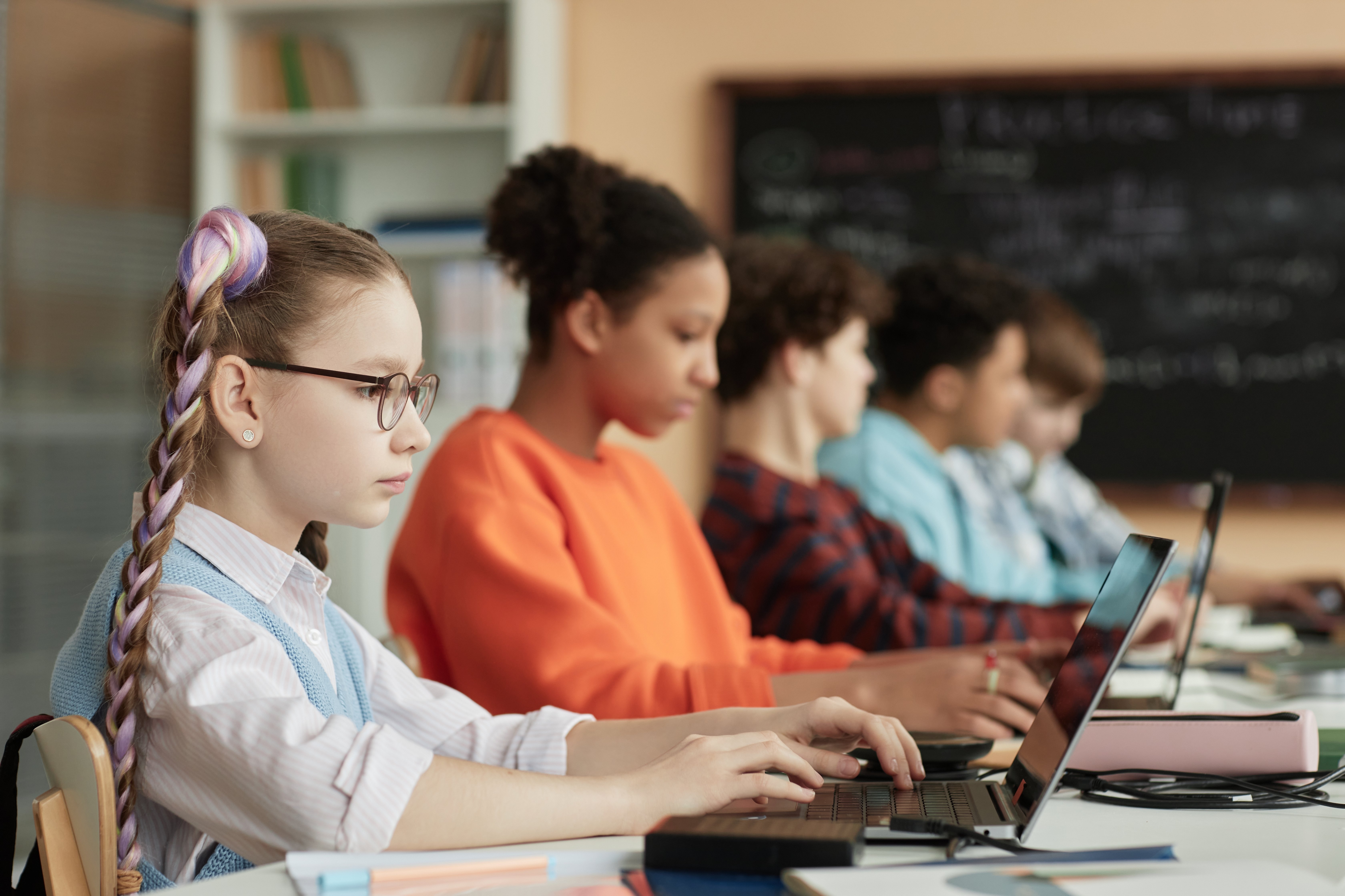 Students using digital devices in class as part of a curriculum aligned with digital learning standards